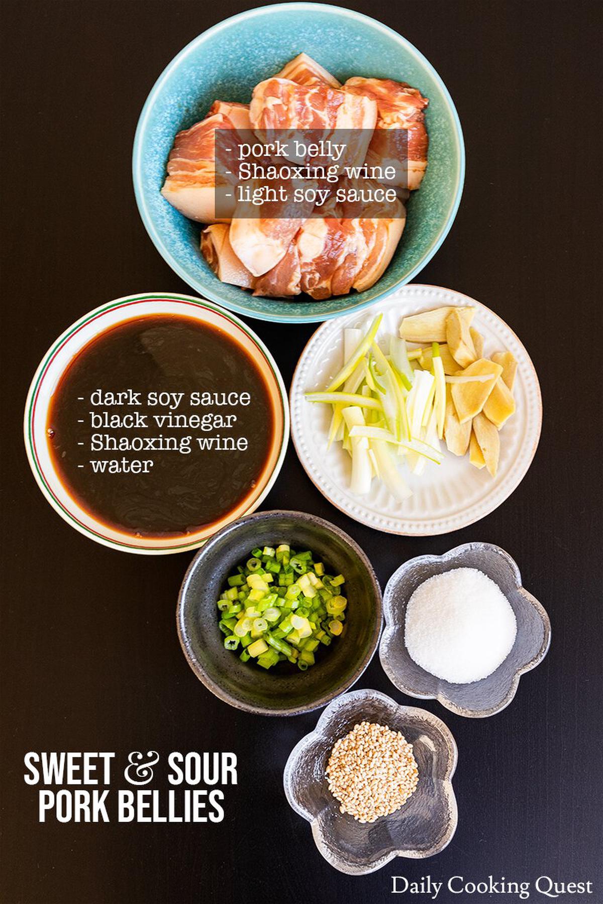 Ingredients to prepare Chinese sweet and sour pork bellies: pork belly, light soy sauce, Shaoxing wine, ginger, scallions, sugar, dark soy sauce, black vinegar, and sesame seeds.