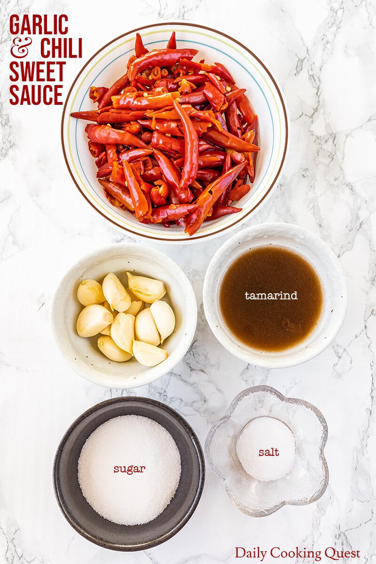 Ingredients for homemade garlic and chili sweet sauce: red chilies, garlic, tamarind, salt, and sugar.