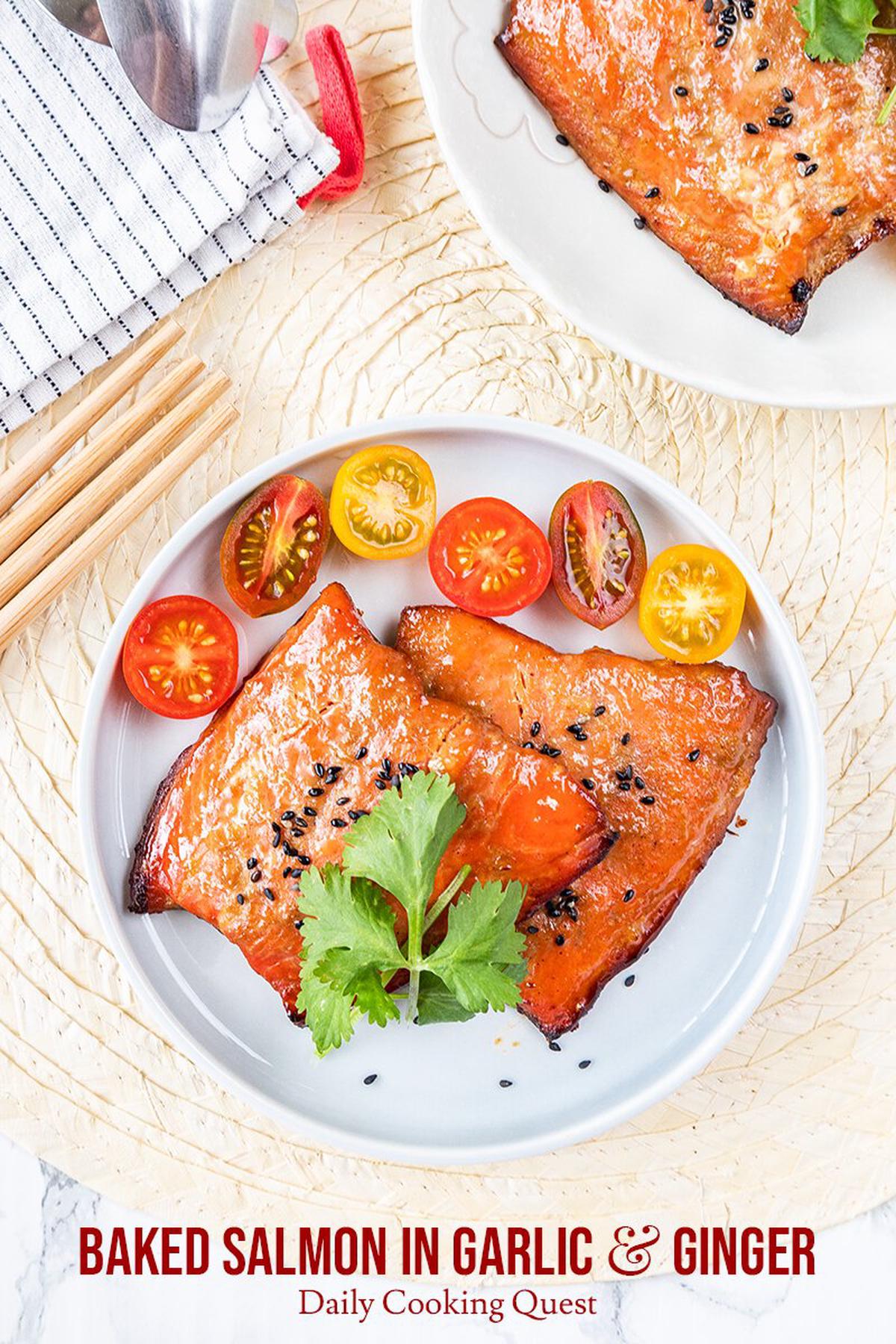 Baked salmon in garlic and ginger, garnished with sesame seeds, and served with cherry tomatoes.